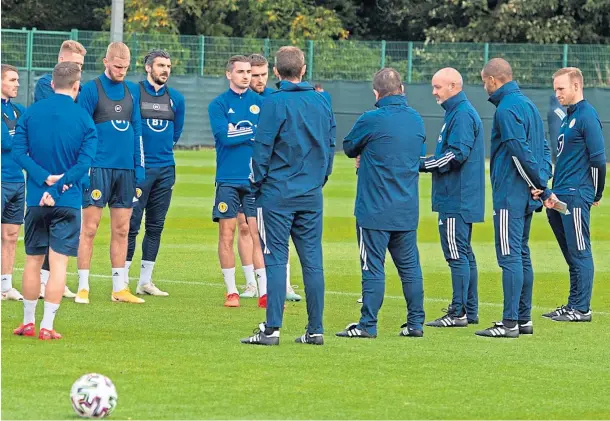  ??  ?? BOSS TALK: National team manager Steve Clarke and his backroom team address Scotland players at yesterday’s training session at the Oriam.