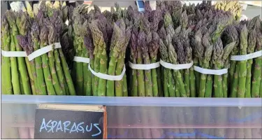  ?? BOULDER COUNTY FARMERS MARKETS — COURTESY PHOTOS ?? Bunches of asparagus from Kiowa Valley Organics line the table of the farm’s booth at the Longmont Farmers Market.