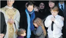  ?? JASON DECROW/The Associated Press ?? Mimi O’Donnell, centre, estranged partner of actor Philip Seymour Hoffman, comforts her daughter Tallulah, along with daughter Willa, left, and
son Cooper, after his funeral Friday in New York.