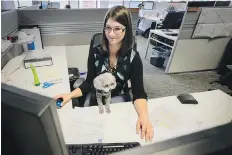  ?? JEFF MCINTOSH/THE CANADIAN PRESS ?? Nicole Wilson at work with her dog Jazzy at Entuitive Corp. Dogs create a “good aura” in the office.