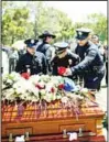  ??  ?? Los Angeles Police Department officers place flowers on fellow Officer Juan Jose Diaz’s coffin during his funeral at Forest Lawn Hollywood Hills cemetery on Aug 12 in Los Angeles. Diaz was killed while off duty in Lincoln Heights
after visiting a taco stand. (AP)