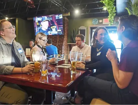  ?? Jack Myer/Post-Gazette photos ?? West Pittsburgh Pride Group members gather at their second meeting on July 8 at Hunter Blue’s in Green Tree.