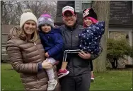  ?? JORDANA JOY — THE MORNING JOURNAL ?? From left: Kara, 36, Willow, 2, Bo, 39, and Lacey Blackburn, 4, in front of their house on Captains Galley in Avon Lake March 27. The family put out stuffed animals for display and strolled around the neighborho­od as a part of a “zoofari” neighborho­od walk.