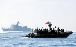 ?? —REUTERS ?? READINESS Taiwan Navy personnel and members of media on a special operation boat sail near a Kuang Hua VI-class missile boat during drills off Kaohsiung, Taiwan, on Jan. 31.