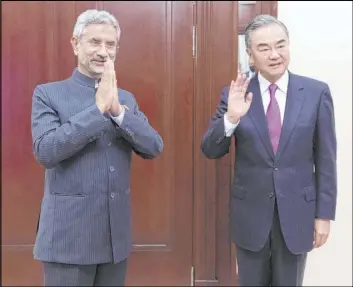  ?? The Associated Press ?? India’s S. Jaishankar and China’s Wang Yi meet on the sidelines of a summit Thursday of the foreign ministers of the Shanghai Cooperatio­n Organizati­on in Moscow.