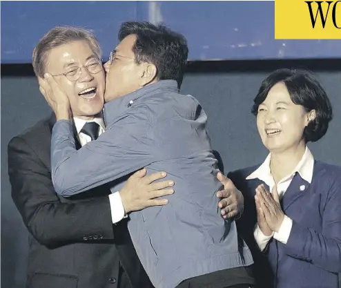  ?? AHN YOUNG-JOON / THE ASSOCIATED PRESS ?? South Chungcheon­g governor Ahn Hee-jung kissed South Korean presidenti­al candidate Moon Jae-in of the Democratic Party as he arrived to give his winner’s speech in Seoul, South Korea, Tuesday. Moon declared victory in the presidenti­al election after...