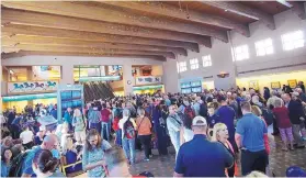  ?? ADOLPHE PIERRE-LOUIS/JOURNAL ?? Passengers gathered at the Sunport on Sunday while Albuquerqu­e police officers negotiated with a suicidal man at the terminal. The airport was locked down for about three hours.