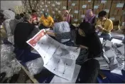  ?? BINSAR BAKKARA — THE ASSOCIATED PRESS FILE ?? Workers fold parliament­ary ballots prepared for the upcoming election at a warehouse in Medan, North Sumatra, Indonesia, Monday.