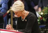  ?? KEVIN LAMARQUE / GETTY IMAGES ?? Cindy McCain, widow of U.S. Sen. John McCain, prays at his casket Friday.