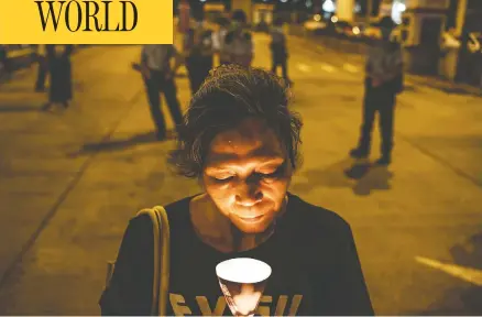  ?? ANTHONY KWAN/GETTY IMAGES ?? A pro-democracy activist takes part in a rally on Wednesday, on the eve of the anniversar­y of the Tiananmen Square Massacre, outside of the Lai Chi Kok Reception Centre in Hong Kong.