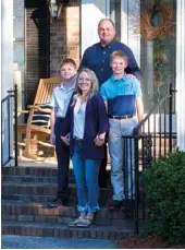  ??  ?? Right: Amy enjoys creating a comfortabl­e home for her husband, Jason, and their sons, 12-year-old Adam (left) and 14-year-old Connor (right), starting with the front porch of their brick ranch.