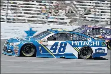  ?? ASSOCIATED PRESS] [LARRY PAPKE/THE ?? Jimmie Johnson (48) and Denny Hamlin, rear, come out of Turn 4 during the NASCAR Cup Series race Sunday at Texas Motor Speedway in Fort Worth, Texas,.