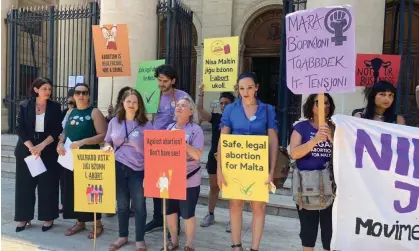  ?? Photograph: Kevin Schembri Orland/AP ?? Activists hold up banners in English and Maltese reading, ‘I decide’, ‘Abortion is a woman's right’ and ‘Abortion is healthcare not a crime’ outside the courts in Valletta, Malta, last June.