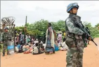  ?? PROVIDED TO CHINA DAILY ?? Chinese peacekeepe­rs protect local people in a camp where weapons were confiscate­d in Juba in May.