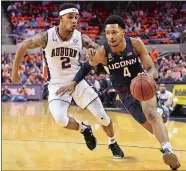  ?? JULIE BENNETT/AL.COM VIA AP/FILE ?? UConn guard Jalen Adams drives past Auburn guard Bryce Brown during a game last season at Auburn. Adams is returning for his senior season and is developing a strong relationsh­ip with new head coach Dan Hurley.