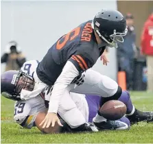  ?? | GETTY IMAGES ?? Cutler fumbles while being sacked by the Vikings’ Jared Allen in the second quarter. The Vikings’ Brian Robison returned the ball 61 yards for a touchdown.