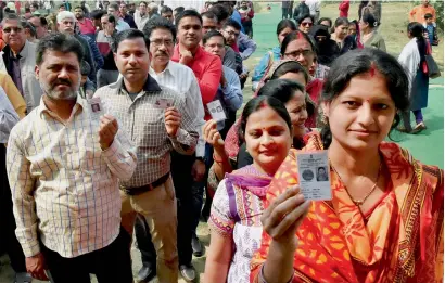  ?? PTI ?? Voters queue up to cast their votes during the third phase of the UP assembly elections in Lucknow on Sunday. —