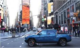  ?? Photograph: Michael M Santiago/Getty Images ?? A Rivian electric truck is seen as it drives through 44th Street in Times Square on 10 November 2021 in New York City. Rivian, an electric truck maker, floated for more than $100bn.