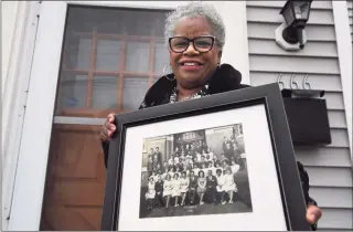  ?? Brian A. Pounds / Hearst Connecticu­t Media ?? State Sen. Marilyn Moore holds the photo of her 8th grade 1962 class from Columbus School in Bridgeport on Thursday. At Columbus, Moore met teacher and civil rights activist Charles Tisdale, who introduced her to the movement.