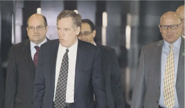  ??  ?? 0 United States trade representa­tive Robert Lighthizer,second from left, on his way to meet Chinese officials in Beijing earlier this month