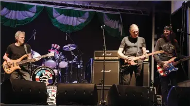  ?? The Sentinel-Record/Grace Brown ?? AMERICAN BAND: Grand Funk Railroad performs a free concert Friday evening on the stage at the east end of Bridge Street. It was the first pre-parade concert performed in conjunctio­n with the community’s annual St. Patrick’s celebratio­n.