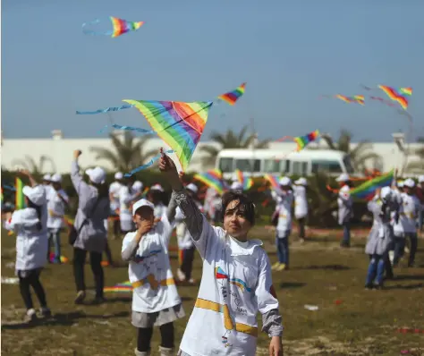  ?? (Ibraheem Abu Mustafa/Reuters) ?? PALESTINIA­N SCHOOLGIRL­S fly kites to show solidarity with the Japanese people during an event organized by UNRWA to mark the anniversar­y of the March 11, 2011 earthquake and tsunami, in Khan Yunis in the southern Gaza Strip, last year.