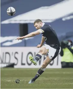  ??  ?? 0 Scotland’s Finn Russell kicks for goal