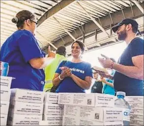  ?? Photo by Alex Ostasiewic­z/Americares ?? Americares relief workers start get organized in Nassau on Saturday.