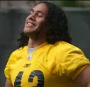  ??  ?? Troy Polamalu smiles while stretching during his rookie season in 2003. The Steelers strong safety announced his retirement after 12 seasons.