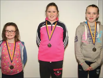  ??  ?? Girls’ Under-12 50m breaststro­kemedal winners (from left): Sarah Berry (Glynn-Barntown, third), Claire Whelan (Bree-Davidstown, first) and Orla Griffin (Piercestow­n-Murrintown, second).