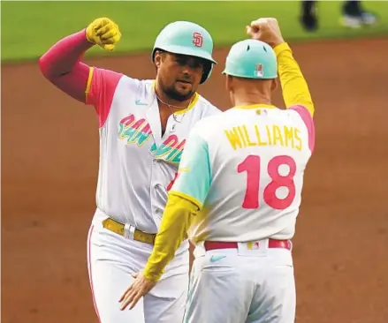  ?? GREGORY BULL AP ?? Padres’ Luke Voit (left) celebrates with third-base coach Matt Williams after hitting a two-run home run during the first inning.