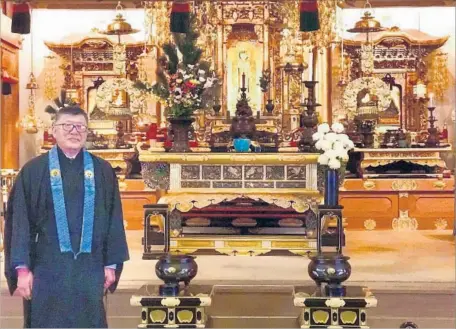  ?? Julie L. Kessler ?? AT THE SAN JOSE Buddhist Church Betsuin, the Rev. Gerald Sakamoto stands in front of gold-plated altars imported from Japan.