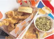  ??  ?? Our dining critic sometimes gets a yearning for Popeyes Louisiana Kitchen’s Cajun rice with spices and ground beef.