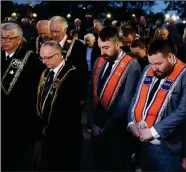  ?? ?? Sir Knights of Co. Fermanagh, Royal Black Institutio­n, and Orange Brethren, bow their heads.