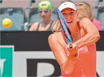  ?? — AFP ?? Maria Sharapova returns a shot to Jarmila Gajdosova during their WTA Tennis Open tournament at the Foro Italico in Rome on Tuesday. Sharapova was leading 6-2, 3-1 when Gajdosova retired with an injury.