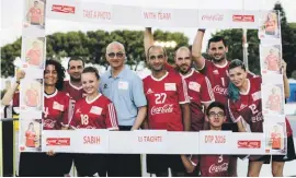  ??  ?? The Coca-Cola team during one of the matches with Fr Martin Micallef, Director of Dar tal-Providenza