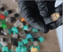  ??  ?? Mock handles a Juul pod at his home in Corte Madera. He says there has been little research on the environmen­tal impacts of the products, which consist of microplast­ics and batteries.