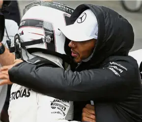  ?? — Reuters ?? Good job man: Mercedes’ Lewis Hamilton hugging Valtteri Bottas who recorded the fastest time in qualifying to claim pole position at the Brazilian Grand Prix on Saturday.