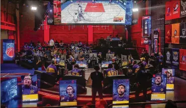  ?? LOS ANGELES TIMES ?? Members of Lakers Gaming play against Kicks Gaming last month. Lakers Gaming is the franchise’s team in the NBA 2K League. The six-member esports squad completed its first season Wednesday.