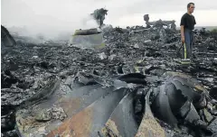  ?? Picture: REUTERS ?? TWISTED METAL: A Ukrainian emergency worker surveys the wreckage of the Malaysia Airlines Boeing 777