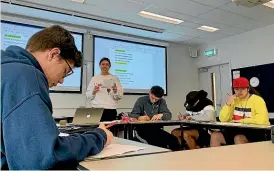  ??  ?? Meschka Seifritz teaches a study session for year 11 students involved in Massey University’s Pu¯horo STEM Academy.
