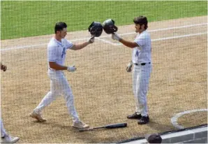  ?? The Sentinel-Record/Brandon Smith ?? National Park’s Jesus Minjarez, right, congratula­tes Cole Rodriguez after Rodriguez hit a home run in the second game of Friday’s doublehead­er against UA Rich Mountain.