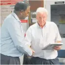  ??  ?? Another QSM recipient Suresh Patel presents Neville with a book on behalf of the Dannevirke Chamber of Commerce to recognise Neville’s 50 years in the Fire Service back in 2014.