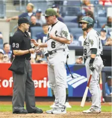  ?? Al Bello / Getty Images ?? Is baseball ready for technology, and not umpires like CB Bucknor, above, to call balls and strikes? It depends on whom you ask. A’s manager Bob Melvin and Jed Lowrie confront umpire Will Little on May 27, when Lowrie received his first ejection.