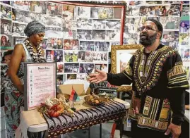  ?? Yi-Chin Lee / Houston Chronicle ?? Deloyd Parker, executive director of the SHAPE Community Center for 47 years, encourages people to start celebratin­g the principles of Kwanzaa after setting up an altar on Saturday.
