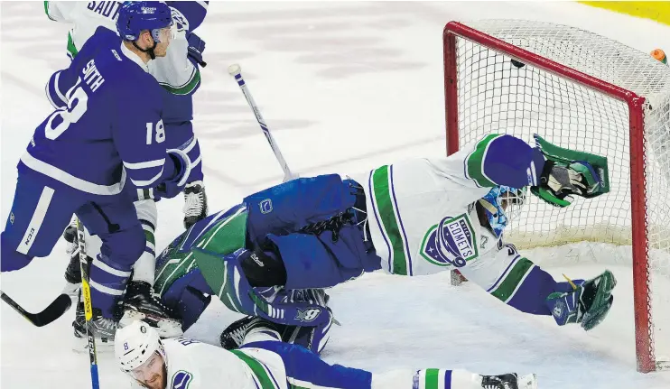  ?? — UTICA COMETS ?? Utica Comets goalie Thatcher Demko dives but can’t make the save on a Toronto Marlies goal during a 5-2 loss in Game 2 of their series Sunday afternoon.