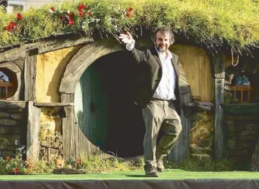  ??  ?? Filmmaker Peter Jackson outside a New Zealand hobbit house.