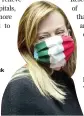  ?? AP ?? Leader of Fratelli d’Italia (Brothers of Italy) party, Giorgia Meloni, wears a mask in the colors of the Italian flag as she attends a session of parliament in Rome on
Thursday.