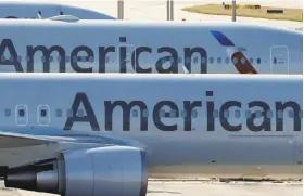  ?? Wilfredo Lee / Associated Press 2017 ?? American Airlines is giving $1,000 bonuses to its employees, but few companies so far have announced any pay raises in recent months.