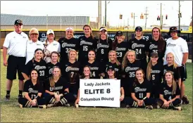  ?? Photos by TIM GODBEE / For the Calhoun Times ?? ( The Calhoun Lady Jackets pose for a group picture after their second-round sweep of Brantley County on Wednesday. ( Calhoun’s Torri Gaddis looks in for the sign during Game 1 on Wednesday.